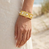 113498, WATER RESISTANT 24K GOLD TONE HALF OVAL PEARL STRETCH BRACELET